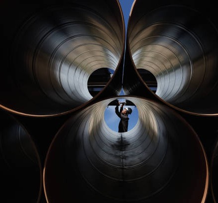 Engineer checking industrial pipes